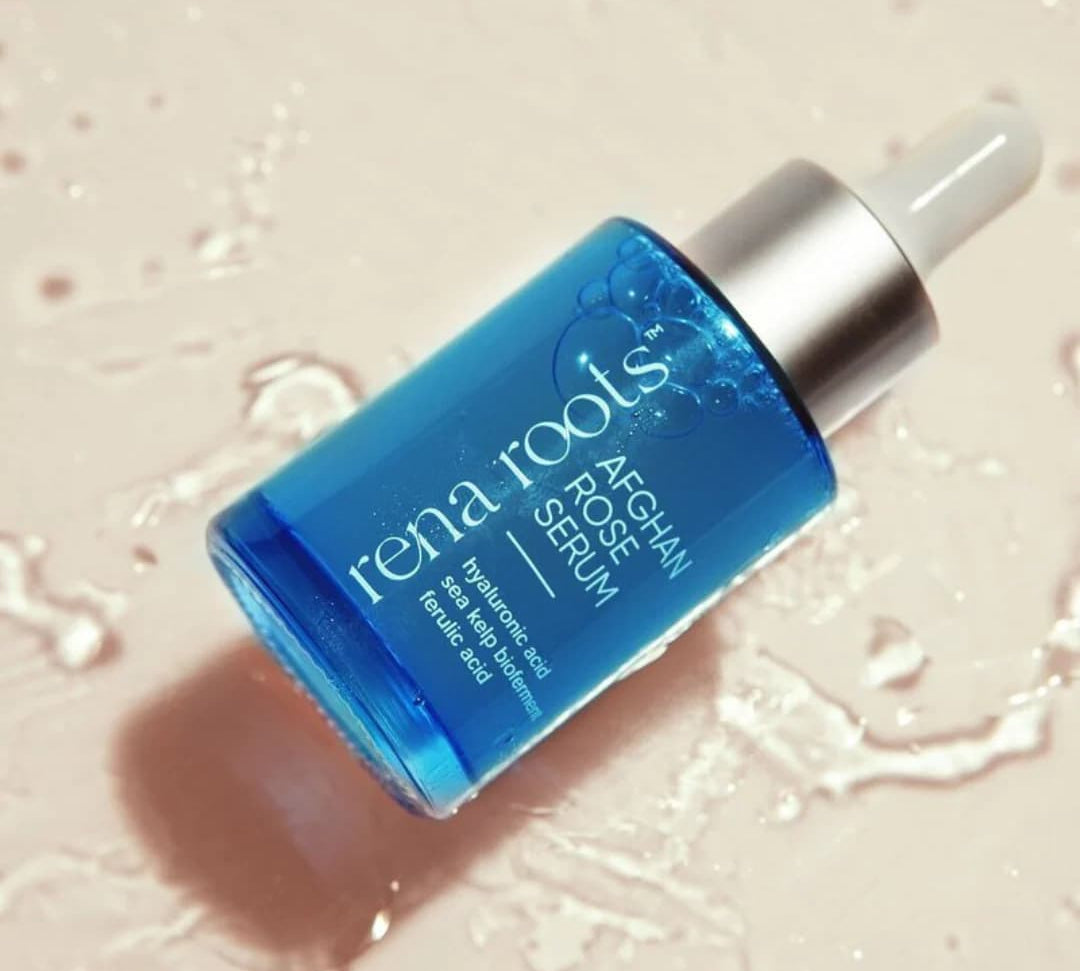 Blue Afghan Rose Serum dropper laying in water